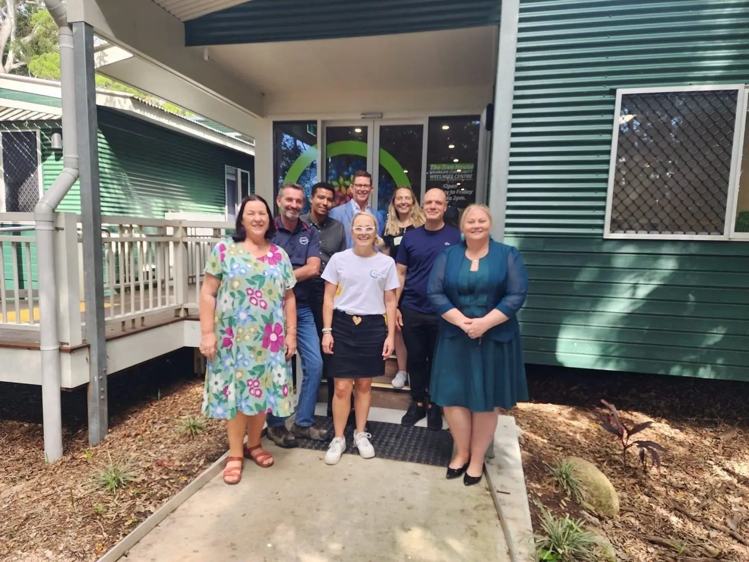 A group of people standing together outside a community wellness centre
